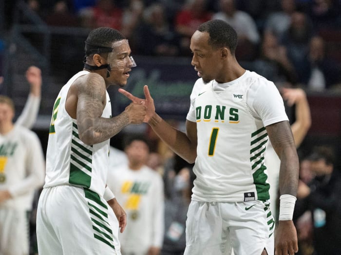 San Francisco’s Jamaree Bouyea (1) celebrates with guard Khalil Shabazz